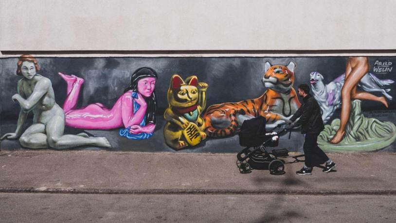 A father walking a stroller in the streets of Vesterbro, Copenhagen.